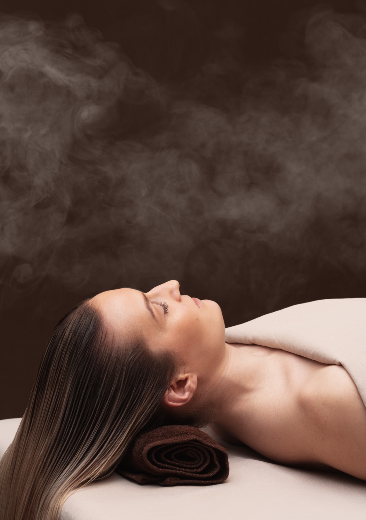 A guest resting under warm steam at the close of a ritual